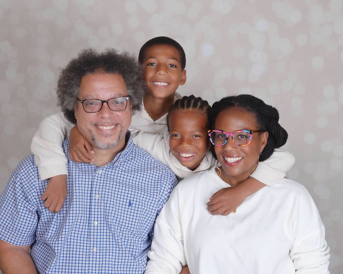 Dr. La Wanda Knox and her husband Zachary, with their two sons hugging them from behind